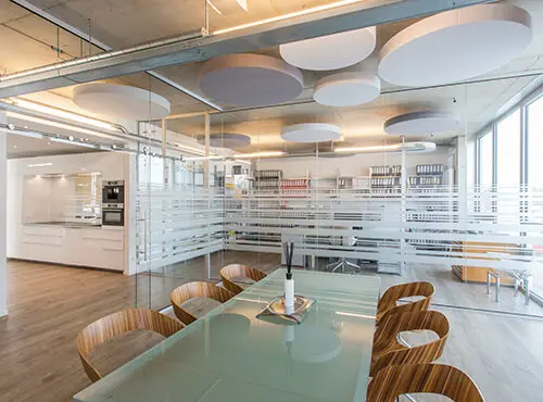 An office with round sound absorbers in order to improve the room acoustics.