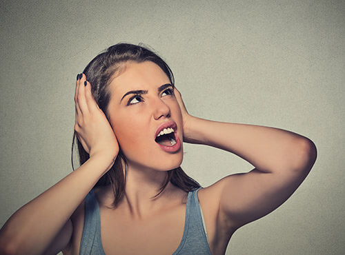 Noise in the home cinema Without soundproofing: A woman is annoyed by the noise from her neighbours' home cinema.