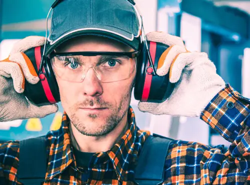 A worker uses ear defenders in order protect himself from noise.