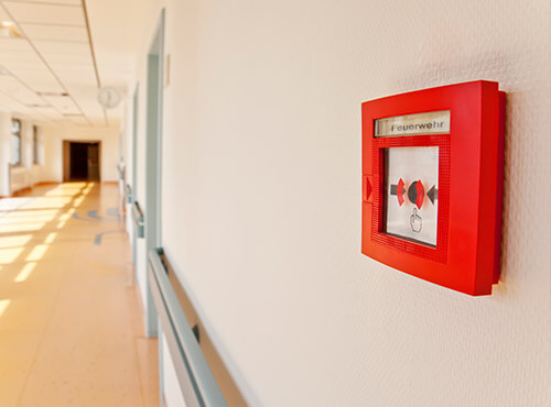 Fire protection and noise insulation in schools and nurseries A fire alarm in a school corridor with sound insulation and soundproofing