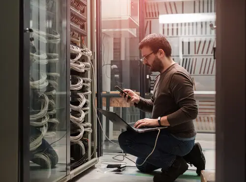 An employee checks the technology in the soundproofed server room.