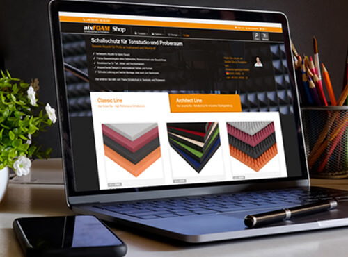 Buy sound absorbers online in the aixFOAM Shop A laptop shows the aixFOAM Online Shop with a selection of sound absorbers and sound insulation products.