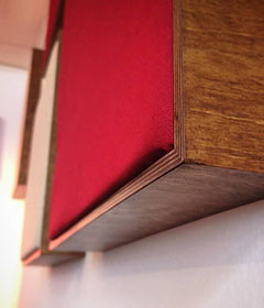 Wooden frame with different coloured acoustic fabric covering
