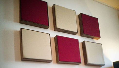 Acoustic wall panels in different colours on the wall